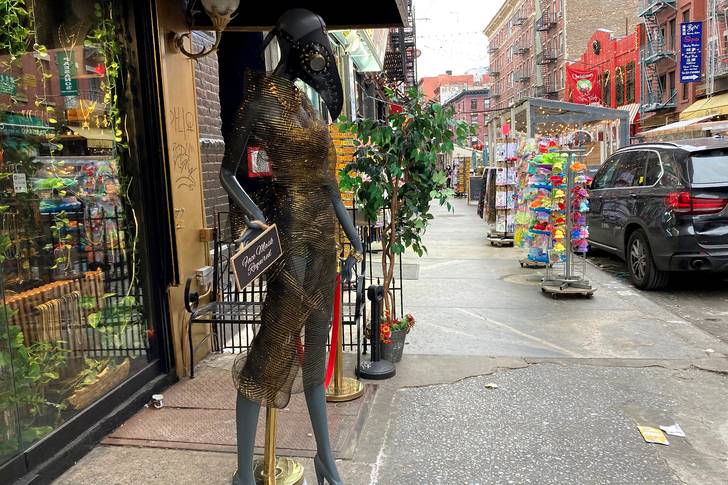A photo of a statue in front of a store on Mulberry Street
